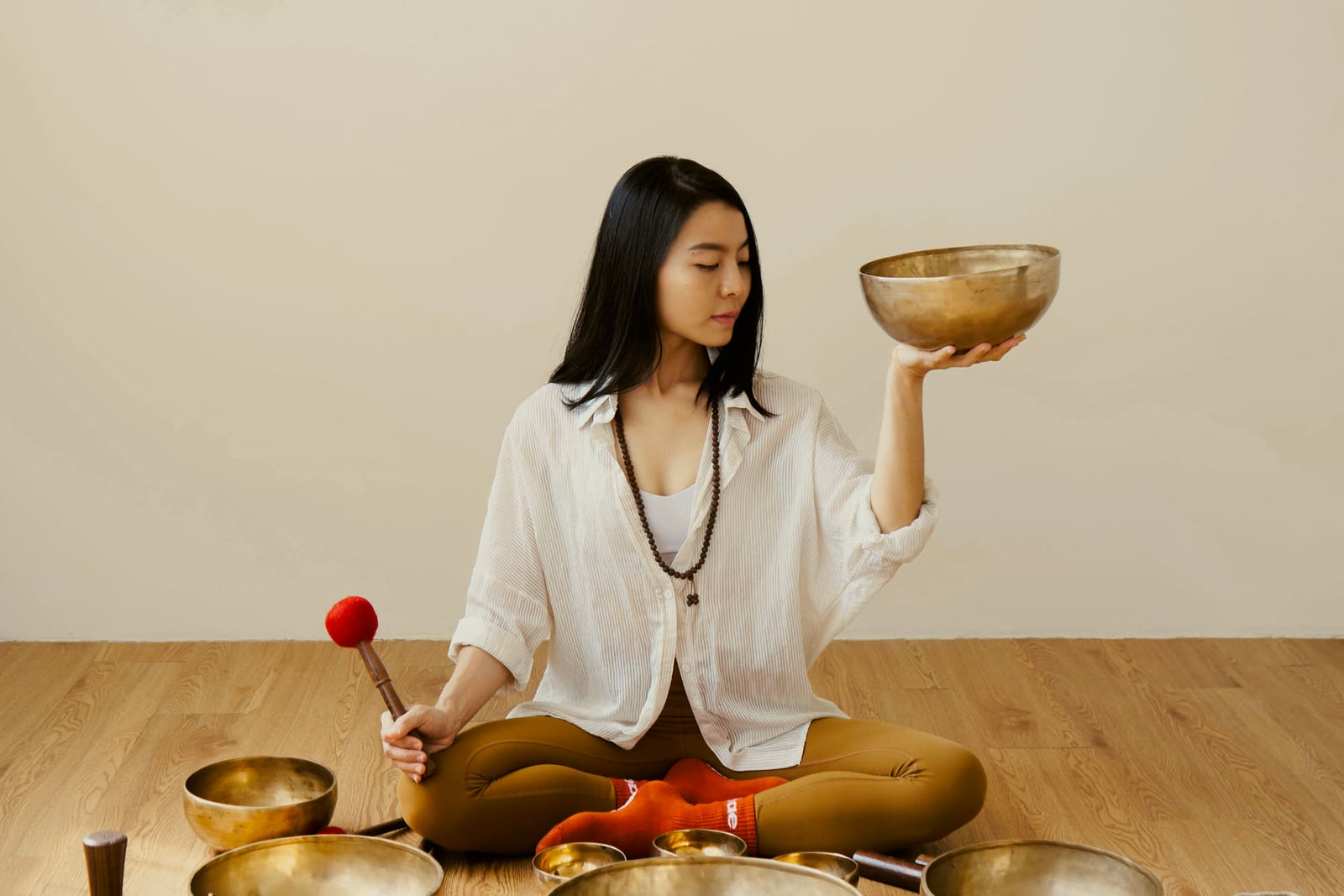 A Hae Studio instructor with a singing bowl during a sound session